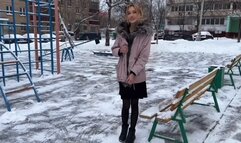 a girl plays on a summer playground in winter at -15 barefoot in stockings and a dress (reupload)