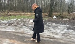 A girl walks in ballet flats on a very bad road where there is slippery ice and slippery mud, her ballet flats slip on such a road and get very dirty