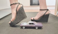 Giantess Raven Lee crushes a 1970 Plymouth GTX toy car in sexy black wedges with painted toenails close up ground view