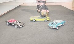 Giantess Raven Lee crushes a 3 classic American convertible toy cars in sexy heels with painted toenails close up ground view