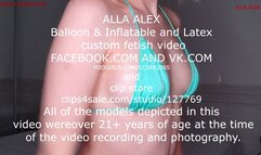 Alla inflates a black inflatable whale with her mouth