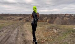 Walk in the forest in a catsuit, high heels, mask