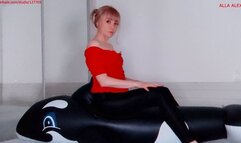 Alla sexily deflates a black inflatable whale with a loud hiss