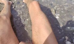 Public nudity sunbathing in the river with a flaccid dick