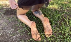 Rubbing and playing with dirty feet in the garden