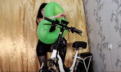 Biker girl inflates an inflatable ring