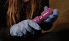 Soaping up a magic wand dildo with latex gloves