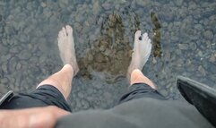 Sweaty, filthy and smelly feet in the river