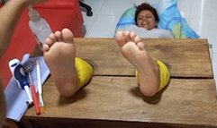 Paula tickles her soles in the vertical stocks