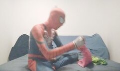 Spiderman is jerking while blowing up balloons