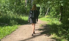 girl walking through the woods in high-heeled shoes and twisted her leg, she very hurt