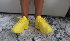 toe wiggleling in yellow soft sneakers a