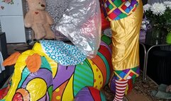 clown girl on infatable rhino play with balloons