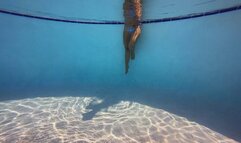 Bikini and mermaid tail in the public pool at the resort