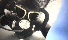 Female Wetsuit Dives in Gasmask Underwater