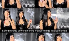 Sexy brunette powersmoking Marlboro Reds in a leather top