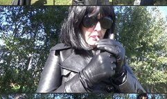 Mistress Angela smokes in a double-breasted leather coat