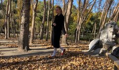 girl in white tights and ballet shoes has fun with fallen leaves, loses her shoes and gets her pantyhose dirty