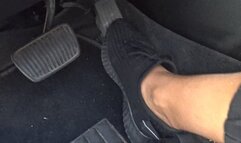 Black sneakers and gas pedal a