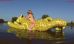 Alla has a hot ride on a tight, squeaky inflatable cheetah on the lake!!!