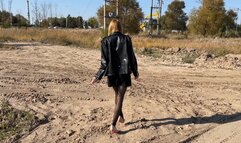 girl in high heels and stockings walks through sticky and deep mud in which her shoes get stuck