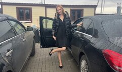 girl in a car plays with her feet in nylon tights