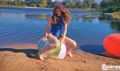 Q906 Cosette rides and deflates big beachball on a lake - 1080p