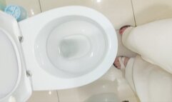 Barefoot Girl Desperately Pissing in the Toilet at Home