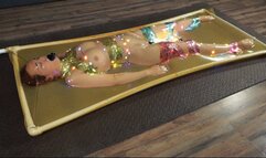 Bondage with tinsel and garland in latex vacuum bed with vibro