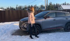 girl in high-heeled boots plays with car pedals