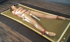 Bondage with red straps in latex bed with vibro