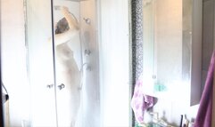 A girl caresses herself in the shower