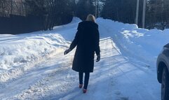 girl in ballet shoes walks along an icy road and slips a lot