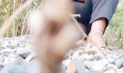 Diana Senior playing with marblestones under her barefeet