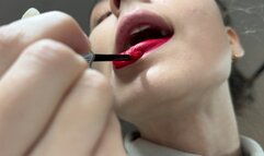 Nastya paints eyelashes and lips with mouth open