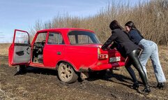 CAR STUCK Two girls in a car stuck in the mud