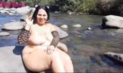 Naked, with cat ears, I masturbate with a giant black dildo in the river