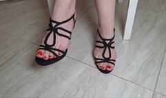 Hostess sore feet in black strappy sandals